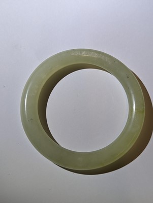 Lot 146 - TWO CHINESE CELADON JADE BANGLES