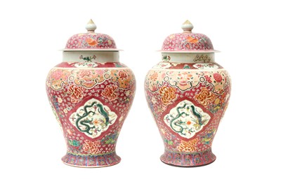 Lot 24 - A PAIR OF CHINESE FAMILLE-ROSE 'DRAGON AND PHOENIX' VASES AND COVERS
