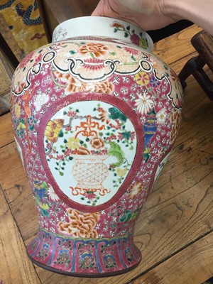 Lot 619 - A PAIR OF CHINESE FAMILLE-ROSE 'DRAGON AND PHOENIX' VASES AND COVERS