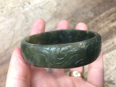 Lot 579 - A CHINESE JADE PENDANT AND A HARDSTONE BANGLE