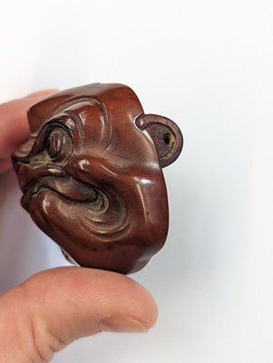 Lot 291 - A JAPANESE WOOD NETSUKE OF A MASK