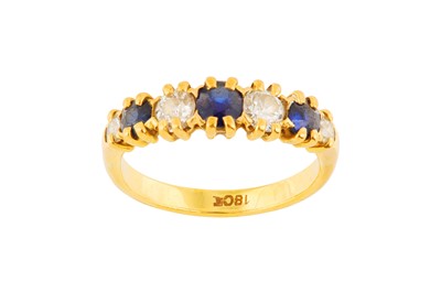Lot 25 - A SEVEN-STONE SAPPHIRE AND DIAMOND RING