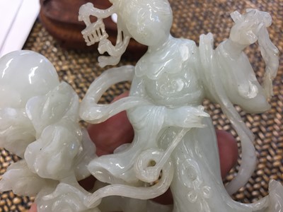 Lot 425 - A CHINESE PALE-CELADON JADE 'CHANG'E AND RABBIT' GROUP