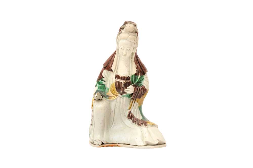 Lot 138 - A CHINESE SANCAI-GLAZED FIGURE OF GUANYIN