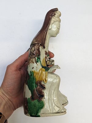 Lot 138 - A CHINESE SANCAI-GLAZED FIGURE OF GUANYIN