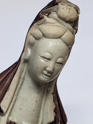 Lot 138 - A CHINESE SANCAI-GLAZED FIGURE OF GUANYIN