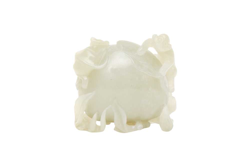 Lot 853 - A CHINESE CELADON JADE 'MONKEYS AND PEACH' CARVING