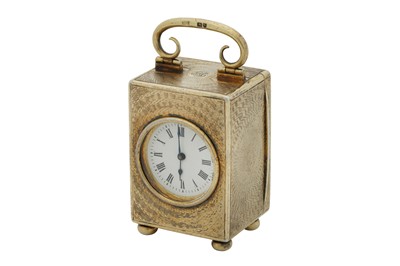 Lot 69 - An Edwardian sterling silver gilt cased travelling time piece or carriage clock, London 1909 by Drew and Sons