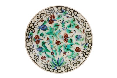Lot 303 - AN IZNIK POTTERY DISH WITH CARNATIONS AND TULIPS