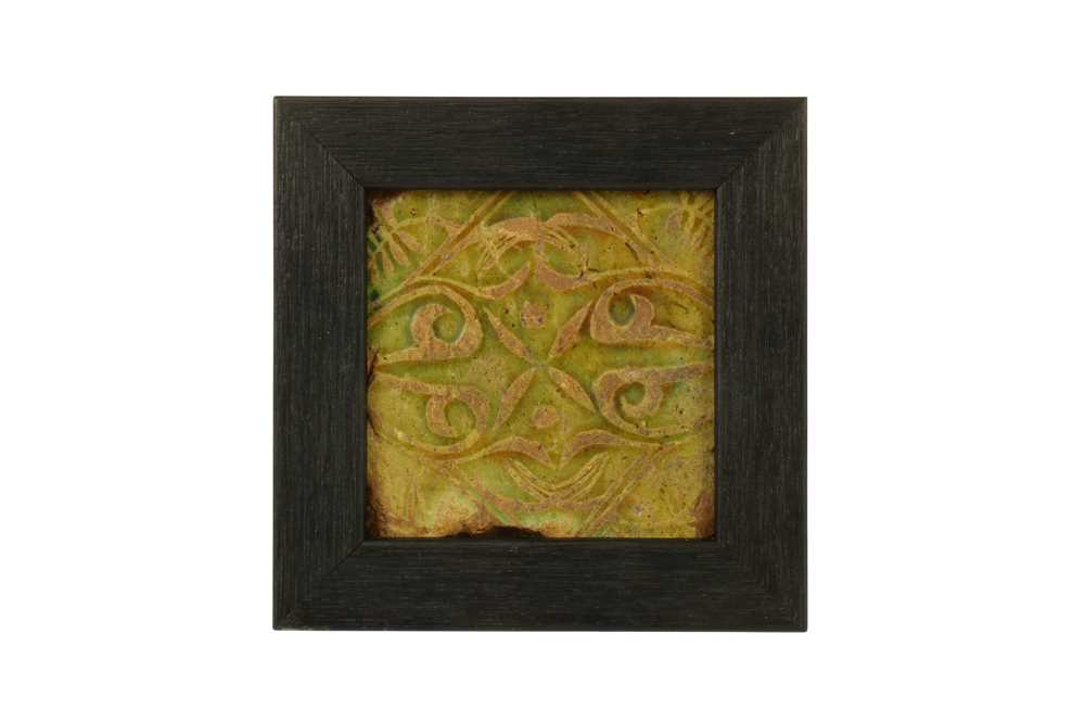Lot 45 - A SMALL MOULDED OLIVE GREEN-GLAZED POTTERY TILE