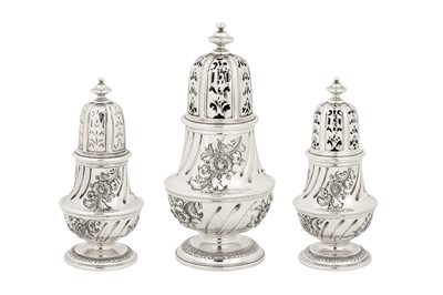 Lot 457 - A graduated set of three early George II sterling silver casters, London 1727 by George Wickes (reg. 3 Feb 1722)