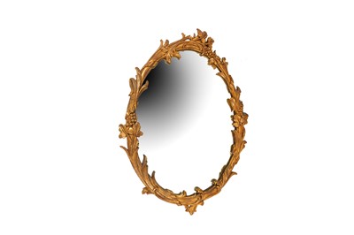 Lot 441 - A CARVED OVAL GILTWOOD WALL MIRROR, 19TH CENTURY AND LATER