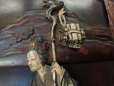 Lot 205 - λ A RARE CHINESE BONE AND IVORY-INLAID HONGMU AND ZITAN 'XIWANGMU' PANEL