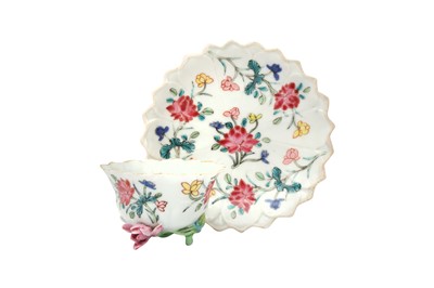 Lot 10 - A CHINESE FAMILLE-ROSE MOULDED 'LOTUS' CUP AND SAUCER