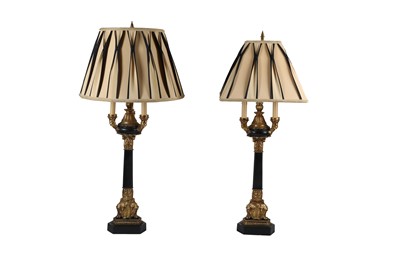Lot 581 - TWO PAIRS OF NEOCLASSICAL STYLE EBONISED AND PARCEL GILT TABLE LAMPS