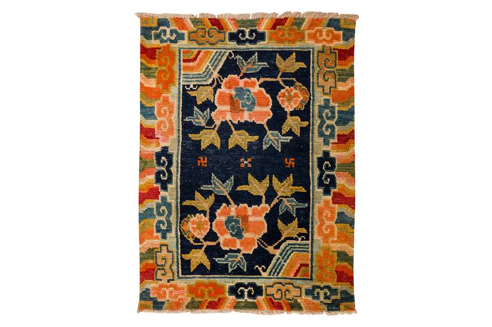 Lot 34 - AN ANTIQUE TIBETAN RUG