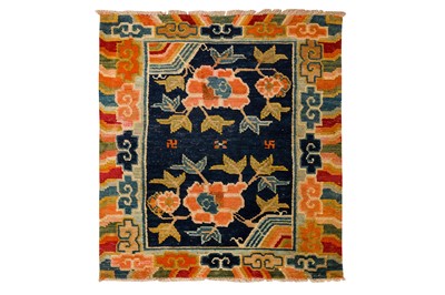 Lot 34 - AN ANTIQUE TIBETAN RUG