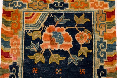 Lot 34 - AN ANTIQUE TIBETAN RUG