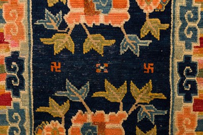 Lot 34 - AN ANTIQUE TIBETAN RUG