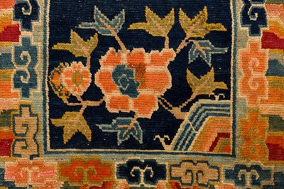 Lot 34 - AN ANTIQUE TIBETAN RUG