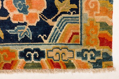 Lot 34 - AN ANTIQUE TIBETAN RUG