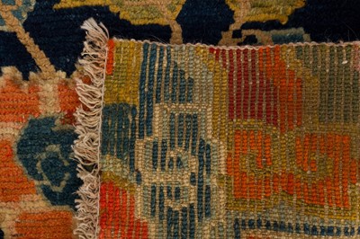 Lot 34 - AN ANTIQUE TIBETAN RUG