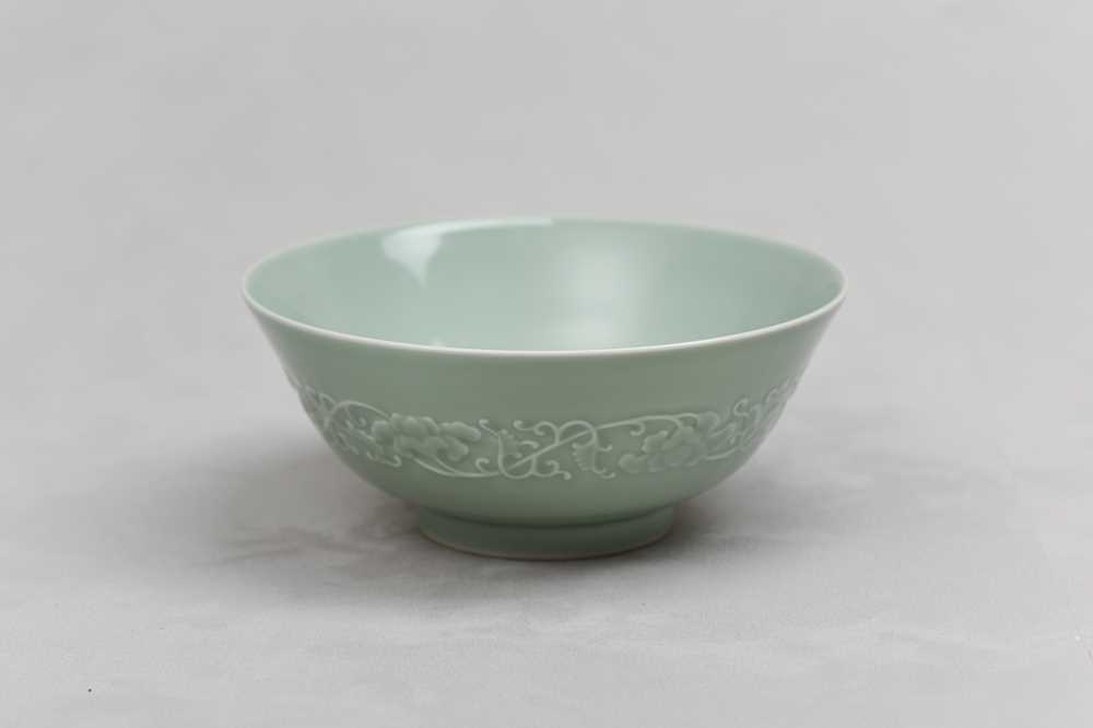 Lot 154 - A CHINESE CELADON-GLAZED MOULDED BOWL