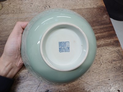 Lot 154 - A CHINESE CELADON-GLAZED MOULDED BOWL