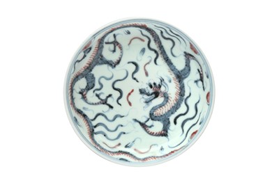 Lot 994 - A JAPANESE BLUE AND WHITE AND COPPER-RED 'DRAGON' DISH