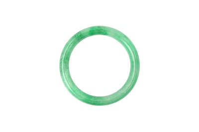 Lot 946 - A CHINESE APPLE-GREEN JADE BANGLE