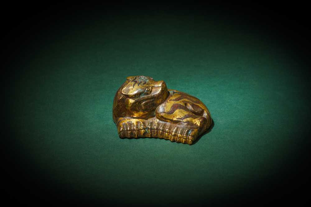 Lot 194 - A CHINESE PARCEL-GILT BRONZE 'TIGER' MAT