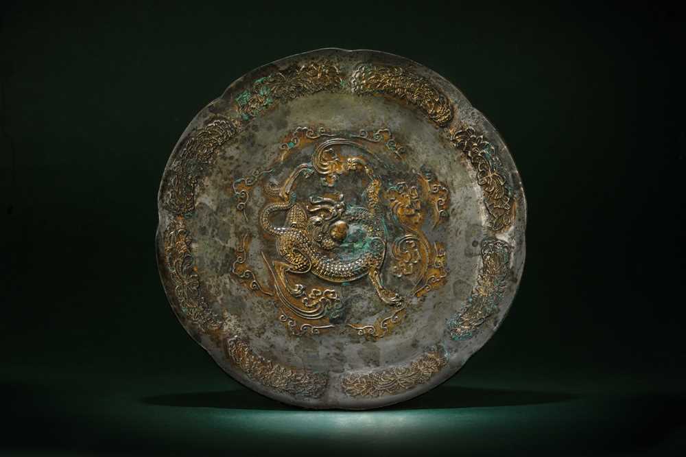 Lot 242 - A CHINESE PARCEL-GILT SILVERED COPPER-ALLOY 'DRAGON' DISH