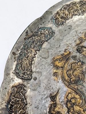 Lot 242 - A CHINESE PARCEL-GILT SILVERED COPPER-ALLOY 'DRAGON' DISH