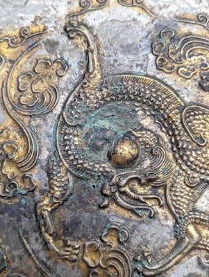 Lot 242 - A CHINESE PARCEL-GILT SILVERED COPPER-ALLOY 'DRAGON' DISH