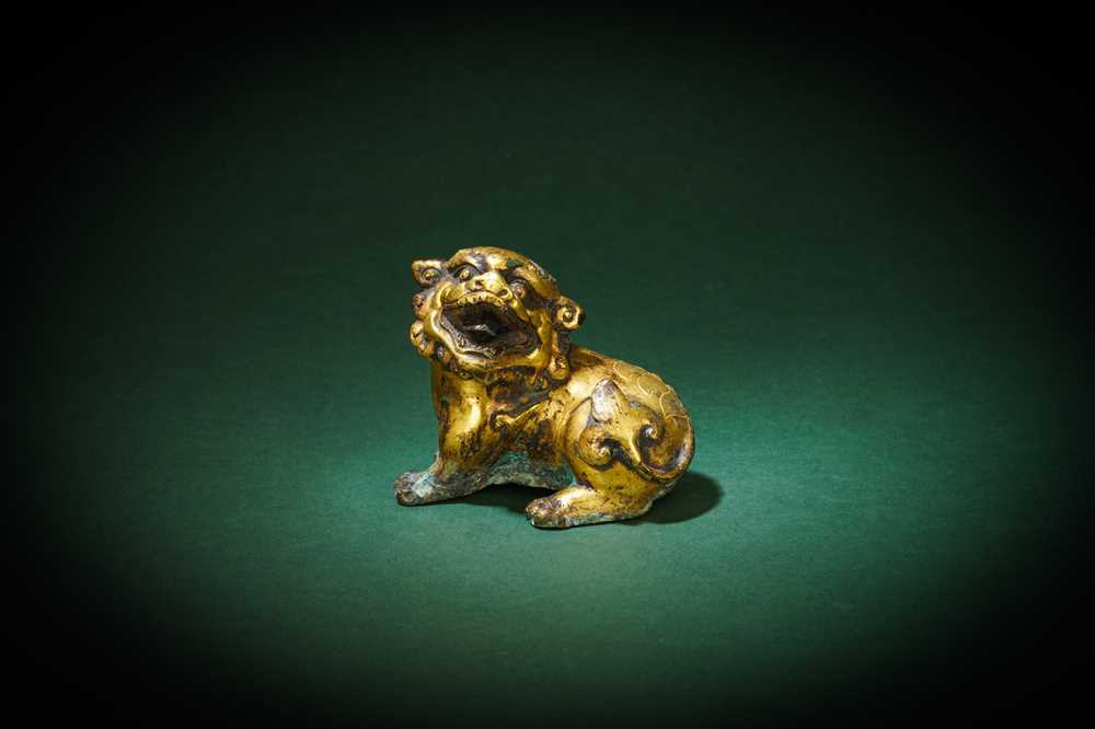 Lot 190 - A CHINESE GILT-BRONZE FIGURE OF A LION