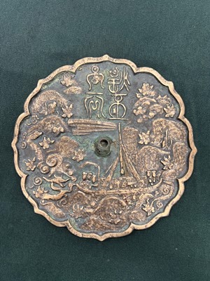 Lot 253 - A CHINESE BRONZE 'DRAGON SLAYER' MIRROR