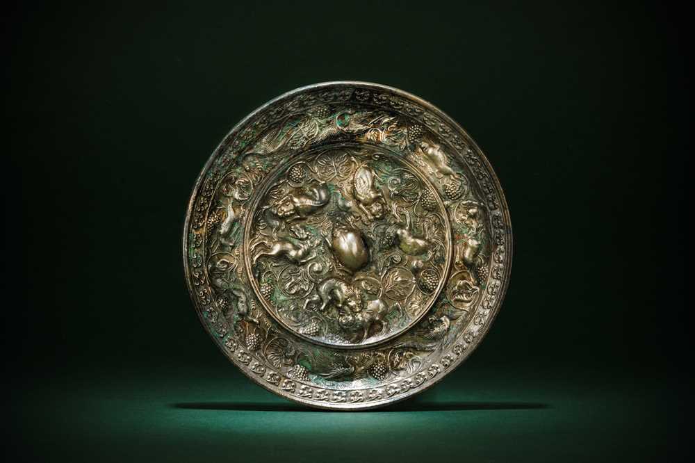 Lot 221 - A CHINESE SILVERED BRONZE 'LION AND GRAPEVINE' MIRROR