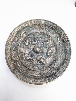 Lot 221 - A CHINESE SILVERED BRONZE 'LION AND GRAPEVINE' MIRROR