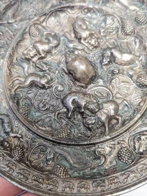 Lot 221 - A CHINESE SILVERED BRONZE 'LION AND GRAPEVINE' MIRROR