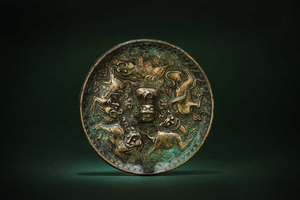 Lot 252 - A SMALL CHINESE BRONZE 'LION' MIRROR