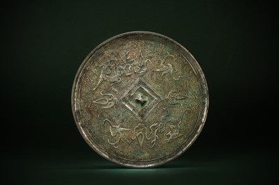 Lot 493 - A CHINESE SILVERED BRONZE 'MYTHICAL BEAST' MIRROR