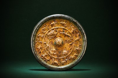 Lot 496 - A CHINESE SILVERED PARCEL-GILT BRONZE 'ZODIAC' MIRROR