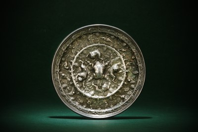 Lot 499 - A CHINESE SILVERED BRONZE 'LION AND GRAPE' MIRROR