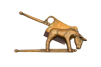 Lot 117 - AN ENGRAVED BRASS BETEL NUT CUTTER WITH A HOLY COW
