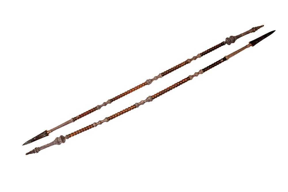 Lot 219 - AN IMPRESSIVE PAIR OF SILVER-MOUNTED WOODEN TEMPLE GUARDIANS (DVARAPALAS) SPEARS