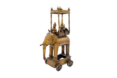 Lot 109 - AN INDIAN MONUMENTAL BRASS TEMPLE TOY ELEPHANT CHARIOT WITH ITS HOWDAH (COVERED BACK CARRIAGE)