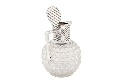 Lot 349 - A Victorian sterling silver mounted glass claret jug, London 1890 by Rupert Favell and Henry Elliott