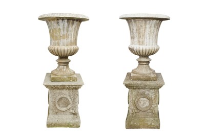 Lot 22 - A PAIR OF RECONSTITUTED STONE CAMPANA URNS ON PLINTHS