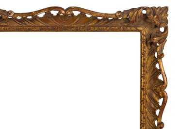 Lot 207 - AN ENGLISH CARVED AND GILDED ROCOCO STYLE SWEPT AND PIERCED FRAME