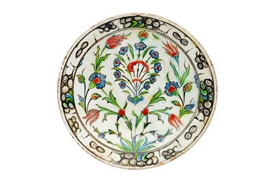 Lot 401 - AN IZNIK POTTERY DISH WITH BLUE ROSETTES AND RED TULIPS